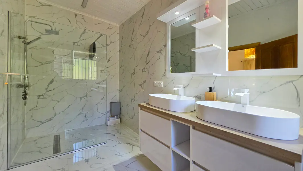 Salle de bains moderne avec double vasque et douche à l'italienne.